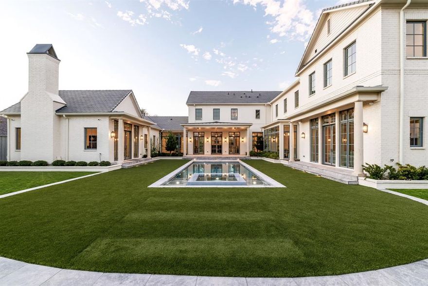 Located in the heart of Preston Hollow, this newly built Georgian-inspired estate by Pierce Jordan Development combines timeless elegance with modern luxury. Set on a half-acre, the 7,900 SqFt home features five bedrooms, six full baths, and two powder rooms, with marble, limestone, and wide-plank wood floors, custom cabinetry, and hand-troweled plaster walls. The chef’s kitchen with Thermador appliances and marble countertops opens to gracious living and dining spaces, while the primary suite offers a floating marble tub, coffee bar, and expansive dressing room with additional laundry. Additional spaces include a study, den, game room, and lounge with bar. Outdoors, enjoy a 40-foot pool and spa, outdoor kitchen, and covered terrace accessed through an indoor loggia — an ideal setting for entertaining or relaxing in style. This estate is exceptional craftsmanship meets sophisticated design in one of Dallas’s most coveted neighborhoods.