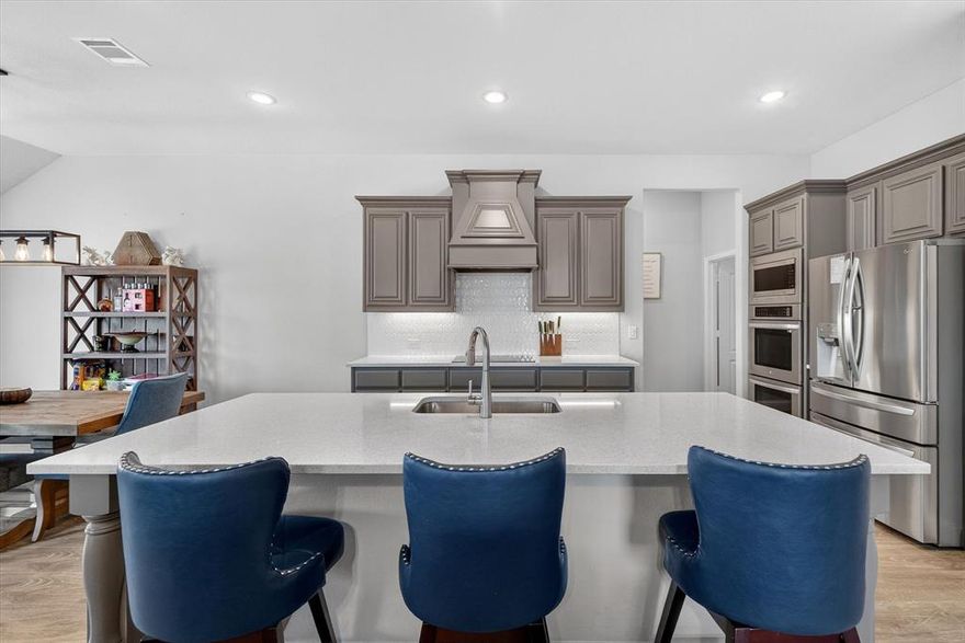 WHY WAIT FOR A HOME TO BE BUILT, WHEN YOU CAN MOVE IN NOW! Located in one of Waxahachie’s growing communities, this beautifully upgraded Caraway floorplan offers 4 bedrooms, 3 full baths, and thoughtful design for multi generational living. At the front of the home, a private bedroom with its own connected full bath creates the perfect in law suite, guest retreat, or private office space. Ideal for the sandwich generation or families needing flexible living arrangements. With 2,458 square feet of open, functional living space, this home stands out from nearby new construction thanks to premium upgrades already completed for you. Gorgeous wood flooring adds warmth and character, while the kitchen features a double oven perfect for holidays and entertaining. The primary suite is designed for comfort and convenience with a double vanity, an oversized shower with built-in seat, and a custom laundry to closet pass through that makes everyday living effortless. Step outside to an extended covered patio overlooking a flat .237-acre backyard. This yard is ready for spring gatherings, playsets, a future pool, or simply enjoying Texas evenings.

Additional standout features include: A full home generator for peace of mind year round. The refrigerator, mounted TVs, can also be yours. Why wait to build when this one already has the upgrades, the lot, and the functionality your family is looking for? This home is ready for a new family to make some memories. 
Ask about lender incentives that are available to you as well.