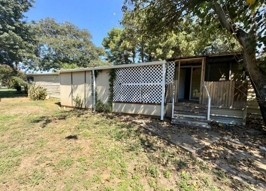 Lake community! Nice corner lot with a mobile home that needs TLC. Handyman special! 2 beds, 2 bath with extra rooms for office or another bedroom. This requires a little more love and not for you HGTV flippers. Lease to own available.