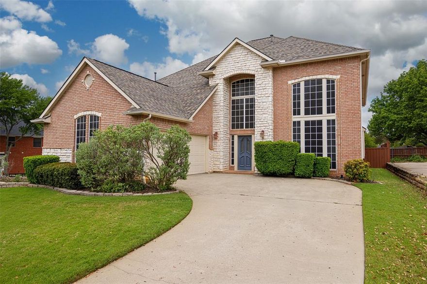 Highland Village show stopper on an oversized corner lot in a private cul de sac! Light and bright with enormous windows that flood every space with natural light. Wood-like tile throughout the first floor common areas is perfect for pets and not having to worry about scratches or dents in your wood floors. Upgraded carpet and pad in all the bedrooms and upstairs. Incredible space throughout the home means never feeling like you're on top of each other. Very large downstairs primary suite with huge windows and a newly remodeled spa-worthy primary bath! Seamless glass shower enclosure, quartz counters, designer black finishes and mirrors, and a soaking tub after long days! Primary closet has a ton of hanging space and room to move around. Formal living with two-story windows and formal dining with passage into the well appointed chef's kitchen. Gas cooktop, newly painted 42in cabinets with pulls, center island, stainless steel appliances, tons of counter prep space, and an eat-in breakfast nook. Spacious first floor living room with gas fireplace and two story windows letting in great natural light. Downstairs powder room convenient to all living spaces. Upstairs we find three more large bedrooms with ceiling fans, a full bath, and a great game room for fun or movie area. Oversized corner lot offers a phenomenal backyard entertaining area large enough to play catch or throw the tennis ball for you pups. Covered patio on the back door gives great space for entertaining and backyard BBQs. Feeding to exemplary primary and intermediate schools and Marcus High School. Conveniently located to shopping, schools, restaurants, and entertainment. Photos don't do it justice. Tour today!