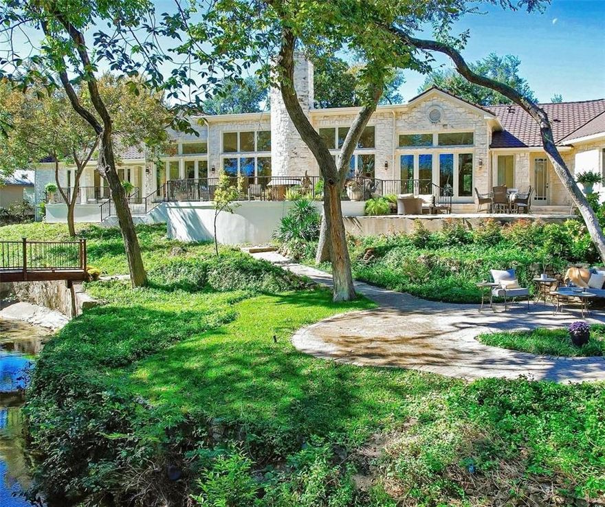 Premium lot and location! One of a kind, single story home perfectly perched on over an acre in Preston Hollow.  Massive open concept living where natural light spills in from double-paned Pella windows that wrap the home with views of the multi-tiered, park like back yard & creek.  This home is an entertainer's dream ready for the new owners customization.  Split bedrooms w private ensuites & separate entrances make this home perfect for multiple generations and guests.  Features include Permian basin limestone floors and columns that are not load bearing, oak floors in bedrooms, new roof & gutters in 2019 (includes warranty).  Foundation is pier and beam *This home can easily be updated for ADA compliance.