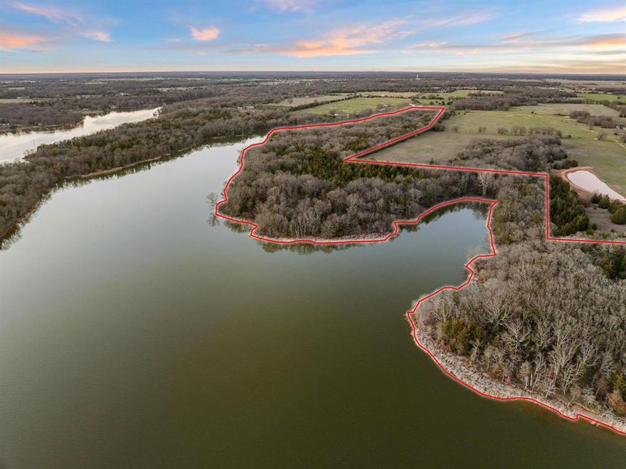 Discover a rare opportunity to own a remarkable 39+- acres of wooded, rugged, waterfront property featuring stunning panoramic views. Nestled on the shores of Bonham Lake, this  land boasts large mature oak trees, rolling terrain, and water access on three sides, making it an ideal setting for exploration and hiking. Whether you envision creating your own private oasis or developing a master-planned community, this property offers endless possibilities. Conveniently located just outside Bonham, you’ll enjoy the tranquility of nature while being less than 15 minutes away from shopping, schools, and restaurants. Don’t miss this chance to make your dreams a reality. ...................Utility providers are City of Bonham for Water and Fannin Electric for Electricity.  Buyers are responsible to verify all cost for development and services. Based on the flood map the majority of the land is in a flood zone. Land will be conveyed pursuant to signing a 99 year lease with the City of Bonham. The City will require the execution of new leases upon the transfer of any portion of the leased property. The City of Bonham has the right to reject all offers. .........Bonham Lake was built in the late 70's, is approximately 1,200 acres and offers, boating, fishing, swimming and camping.