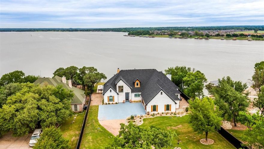 Fully updated. One of a kind. Waterfront oasis. This only begins to describe this immaculate lake house in Granbury, TX. Without an inch of this home being untouched by pure beauty, there will be no reason to look any further! Your new 4 bed, 3.5 bath haven has been updated in every way, including... All new paint, inside and out. (Including cabinetry). Newly installed 40 year shingled roof. New outdoor kitchen and pergola with a never been used Lynx Grill. A 6 ft board on board privacy fence surrounding the property, creating your own private fortress. The fence has been perfectly teamed up with a solar powered electric wrought iron gate. The home has all new energy efficient Pella windows and doors with new blinds, including electric blinds over the new master bedroom sliding door. All flooring has been replaced and or stripped and retreated. Parts of the dock and retaining wall have been rebuilt. Brand new ADT alarm system. All furniture and pontoon boat are available as well.