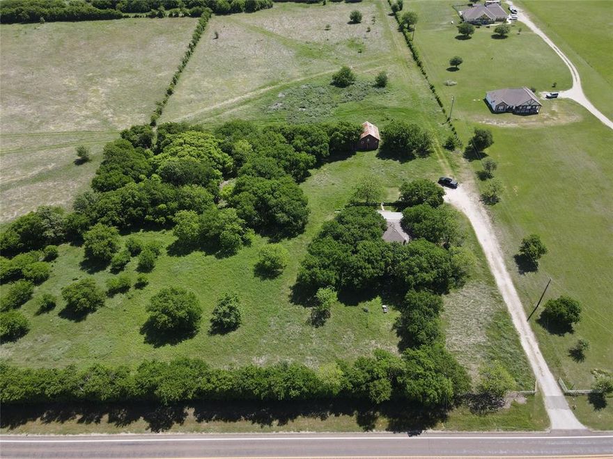 Discover the perfect blend of country charm and affordability at this inviting property situated on 2 acres along FM 1173 in Krum, Texas.
A gated entry directly off FM 1173 welcomes you onto the property, adding both convenience and an added sense of privacy and security. The access makes it easy to come and go while maintaining a defined and attractive entrance to your acreage.  One of the most appealing aspects of this property is its versatility. You have the unique opportunity to comfortably live in the existing home while building your dream home on the same land. With ample space across the 2 acre lot, you can design and construct a new residence tailored to your vision, all while avoiding the hassle and expense of temporary housing during the build process.  The property is serviced by Bolivar Water, offering a reliable and established water source which is an important feature for rural properties that adds peace of mind and long term value. Whether you’re looking for a place to settle in, invest, or create your forever homestead, this property delivers flexibility, functionality, and the freedom of country living just minutes from town.