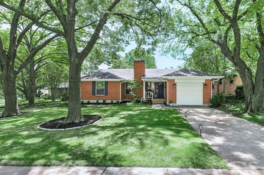 Don’t miss this charming jewel box tucked beneath a canopy of mature oaks just steps from White Rock Lake. Located in the highly sought-after Hexter Elementary School attendance zone, this light-filled home blends character, comfort, and an unbeatable location. Step inside to a welcoming living area anchored by a cozy wood-burning brick fireplace—the heart of the home—complemented by beautifully refinished original light oak hardwood floors that flow throughout. The spacious dining area is perfect for hosting gatherings or everyday meals. The eat-in kitchen offers both style and function, featuring granite countertops, light wood shaker cabinetry, distinctive Saltillo tile floors, a center island, and a full-size built-in desk-workspace—ideal for working from home or staying organized. This home includes three bedrooms and two beautifully updated bathrooms. The primary suite features a sleek walk-in shower, while the guest bath showcases a chic tiled tub. A dedicated full-size washer and dryer area adds convenience. Out back, enjoy a generously sized yard designed for relaxing and entertaining, complete with a seating area and expansive grassy space perfect for play or gatherings. All of this within walking distance to White Rock Lake, neighborhood dining, and local shops. Just minutes to the Arboretum, downtown Dallas and Love Field.