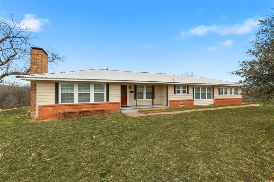 Spectacular 1 acre property with panoramic views overlooking Cottonwood Creek. This restored home features large rooms, a flexible floor plan, and hardwood flooring in select areas. Spacious dining area and cozy fireplace create a welcoming gathering space. Enjoy scenic sunsets and wildlife from the rear deck. Major updates include a 2014 metal roof, new ductwork, insulation, vents, and blinds for improved comfort and efficiency. Fully fenced acreage offers privacy and room to roam, plus an attached 2 car garage for convenience. Easy access to Ennis and Kaufman provides the perfect blend of peaceful country living and commuter accessibility.