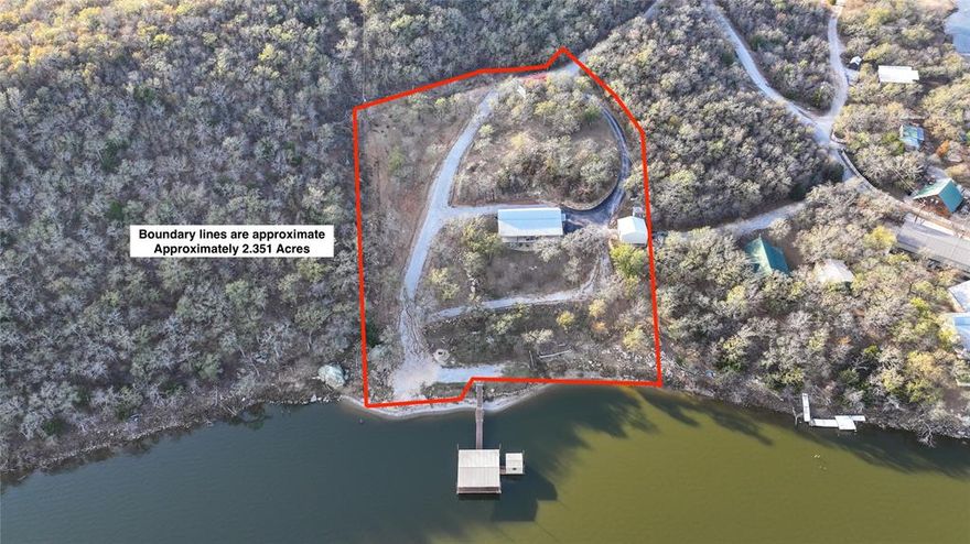 LAKE HOUSE DREAM less than an hour from DFW complete with privacy and breathtaking views! Welcome to Amon G. Carter Lake, where 180-degree panoramas and unforgettable memories await. Whether you're seeking the perfect lake retreat or an income-producing Airbnb, this stunning 2014 custom-built home with a durable metal roof delivers it all. Perched on over 2.30 acres of manicured, park-like land, the home is tucked among mature hardwoods, offering both shade and serenity.  Inside, the grand open-concept living area showcases expansive windows that capture lake views from every bedroom. Step outside to your private covered NEW dock, ideal for fishing, boating, swimming, fish for Crappie in the new Crappie house while relaxing as the sun sets over the water. Evenings are made for gathering around the custom stone fire pit, and there’s plenty of room to play, explore, or unwind.  A spacious 24x24 shop provides excellent storage, workspace, or hobby room opportunities, while a well-maintained asphalt driveway ensures smooth, easy access to the home. RV cover and hook up ready to go or add tiny home there for added living space.  Located just a stone’s throw from Top O The Lake Golf Course, this exceptional furnished property combines luxury, recreation, and peaceful lake living—all in one unforgettable package.