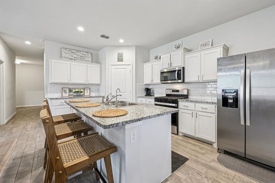 5 BEDROOMS, ONE STORY IN BAILEY PARK.
Hard to find 5 bedroom, 2 bath DR Horton Jaxon plan in West Fort Worth’s Bailey Park community with pool, playground and Little Acorn Park. Open concept living, dining and large kitchen with island, granite counters, gas range, built in microwave, stainless steel appliances, walk in pantry and smart home technology. Built in 2023 with split bedroom layout, private primary suite with dual sink vanity, oversized walk in shower, walk in closet and cultured marble vanities in both baths. Tile flooring in entry, halls and wet areas for easy care. Outside features a covered front porch and covered back patio, full gutters, landscaped yard with sprinkler system, storage shed that stays, and 6 foot privacy fenced backyard ready for relaxing or entertaining. Home still carries DR Horton’s 10 year structural warranty that transfers to the new owner. Convenient to DFW Airport, Fort Worth Nature Center, Sundance Square, Alliance shopping and major highways, while enjoying the quiet neighborhood feel of Bailey Park.