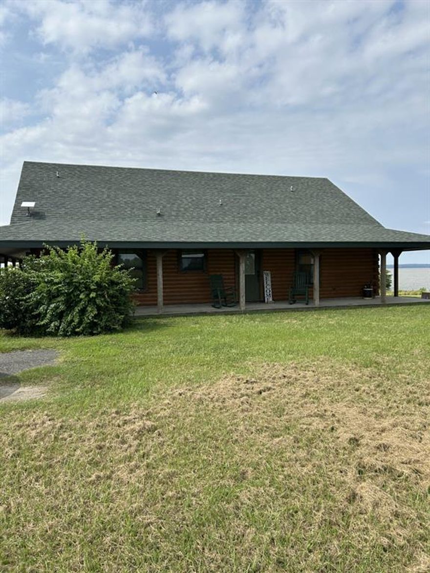 Beautiful log home situated on one acre on Toledo Bend Reservoir!!  Looking for a weekend getaway or looking forward to a new retirement home?  Home is a 2 bedroom with 1 bath.  Open floor-plan with lots of window to look out to the Lake.  Has a wrap-around porch.  Also has a 35 X 30 shop that has electric and is sealed with spray foam insulation and AC.  There is also a garage, with nice bar area, with outdoor kitchen area (1392 HSF) and a screened- in patio for relaxing or entertaining.  You also have a boat house with small pier....This is a gated subdivision and does have a yearly HOA.
Zoned for Stanley school zone and is on the bus route.  Home does not require flood insurance.