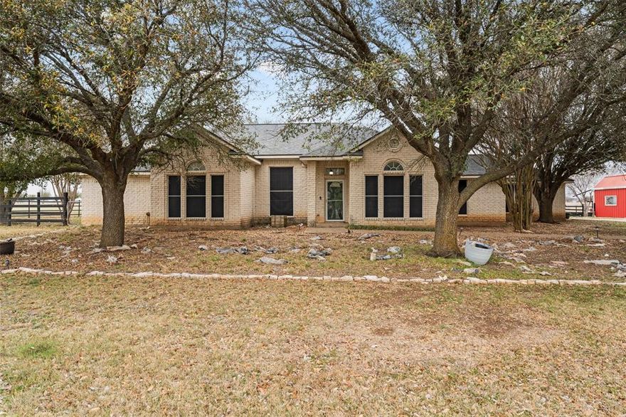 Escape to the perfect blend of country living and modern comfort with this beautiful 4-bedroom, 3-bath Austin stone home situated on 5 fully fenced acres. Offering privacy, space, and versatility, this property is ideal for families, hobby farmers, or anyone looking for room to spread out while still being within easy reach of nearby amenities. Inside, the home features spacious, light-filled living areas accented with stone details and a functional open layout designed for everyday living and entertaining. A dedicated home office provides the perfect space for remote work, study, or a flex room. The kitchen offers ample counter space and cabinetry, making it both practical and welcoming for gatherings. Recent upgrades include two water heaters, central HVAC units, and a roof all approximately two years old, providing peace of mind for the next owner. Step outside to enjoy a private backyard retreat complete with a covered patio and relaxing hot tub, perfect for unwinding or hosting friends and family. The property also includes a detached shop workshop and a barn, offering excellent space for equipment, hobbies, animals, or storage. The fully fenced and cross-fenced acreage is ready for livestock, pets, or pasture use, while mature trees and open space create a peaceful country setting.
This property offers the best of rural charm with comfortable, move-in-ready living.