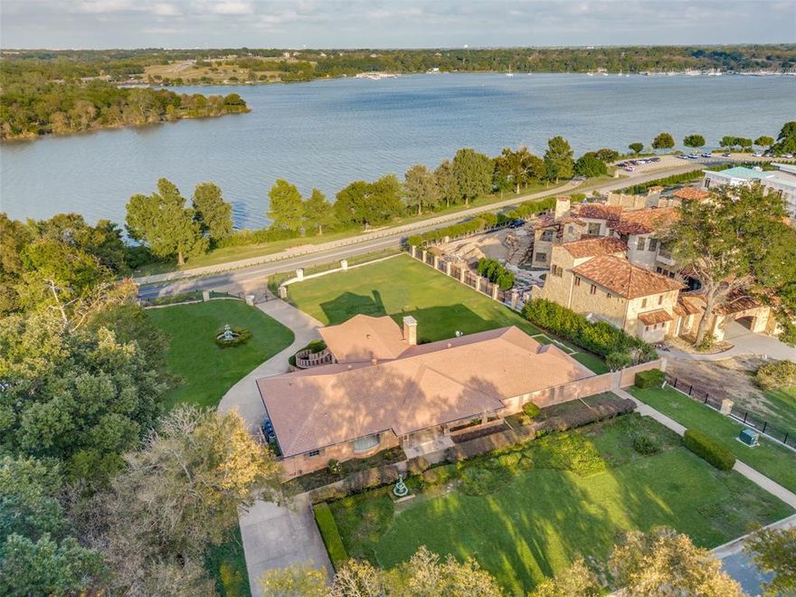 Waterfront property offers unparalleled unobstructed views of White Rock Lake. Incredible custom build site or the opportunity to restore this amazing mid-century modern estate on a ONE ACRE hilltop site. Beautiful expansive grounds and huge outdoor terrace maximize this prime lakefront setting. Large foyer showcases terrazzo flooring and is flanked by the formal living and dining areas. The oversized great room is accentuated by high ceilings and a wall of windows overlooking the lake, accessing a balcony with dual stairways descending onto the generously sized backyard. Chef's island kitchen features double Miele ovens, Bosch 5 burner gas cooktop, built-in refrigerator, modern cabinetry, natural stone counter tops and a white granite farm sink. Primary suite with dual bathrooms, walk-in closets, and a spectacular view of the lake. Plans and renderings by Manolo Design Studio have been permitted by the city and are available for those seeking a new-build in a legacy location.