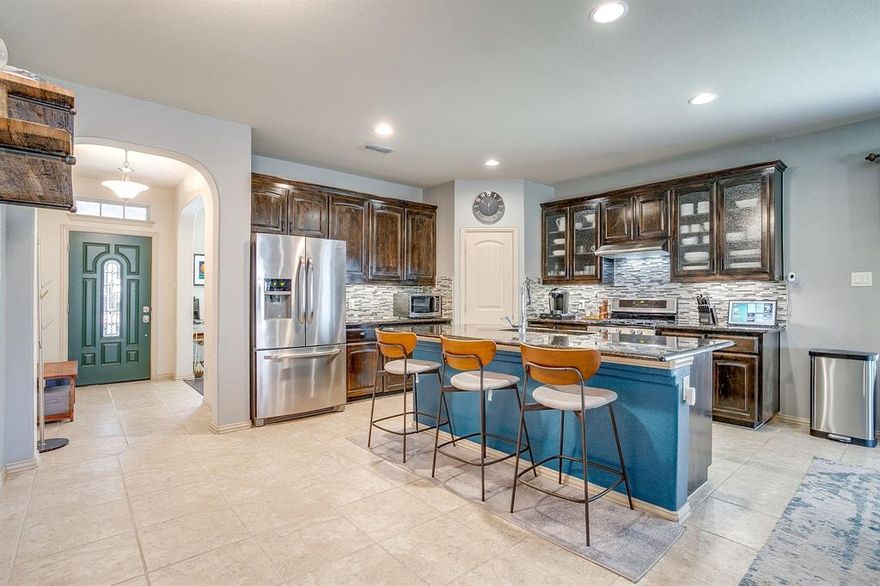 Beautifully Maintained One Owner Home in Highly Desirable Keller ISD. Welcome to this immaculate home offering the perfect blend of comfort, space&thoughtful design. Located with easy access to 35W & 170 for effortless commuting. This home has been exceptionally cared for & includes a new roof with upgraded shingles & privacy fence. Both the front & backyards are beautifully maintained & have a full sprinkler system. With 4 bedrooms + office, 2.5 bathrooms & 2 spacious living areas, this home provides flexible living options for every lifestyle. Step inside to a tiled entryway that opens to a private office. The main floor features a bright, open concept layout with tall ceilings, rounded archways, recessed lighting & abundant natural light. The spacious living room includes rich dark wood flooring, a gas starter fireplace & a custom built-in entertainment center. A large picture window - beautiful view of the backyard.The gourmet kitchen is designed for both everyday living & entertaining: a spacious center island with seating, granite countertops, SS appliances including double ovens, a gas cooktop, microwave, refrigerator, dishwasher & double sinks. Tile flooring, ample cabinet storage & a walk in pantry complete this highly functional space.Your 1st floor primary suite is a peaceful retreat : wood flooring, tall ceilings & a ceiling fan. Double doors open to the spa inspired ensuite: a separate tiled walk in shower, relaxing soaking tub, dual sinks with expansive countertop & vanity space, decorative lighting & an oversized walk in closet— exceptional storage.Upstairs, a large 2nd  living area—perfect as a game room, media room, or bonus space. You’ll find 3 oversized bedrooms each with walk in closets & ceiling fans. A full bathroom & 2 additional storage closets.Outdoor living shines with a covered patio, lighting, sunshades, custom pathways & lush landscaping. The backyard includes a storage unit.See full list of upgrades, HOA info, Matterport tour&floorplan!