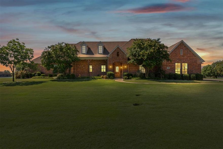 NOW OFFERED FULLY FURNISHED - This stunning waterfront property is located in one of the few water ski communities in North Texas: the beautiful Princeton Lakes neighborhood. Set on just over an acre, this single-story home boasts an open floor plan that perfectly combines luxury and comfort. It features 4 bedrooms, including two primary suites, 3 full bathrooms, soaring 12 feet ceilings, a built-in mudroom, and a laundry room equipped with built-in cabinets and a sink topped with granite counters, and lake views from every room. The garage is expansive, covering over 1000 square feet, providing ample space for a boat, golf cart, and cars, with additional room for a workshop. The backyard is ideal for entertaining! The 420 square foot covered patio comes with built-in electronic shades, a mini fridge, and a TV, all while overlooking the breathtaking infinity pool that can be enjoyed year-round. You can heat it in the winter or cool it off in the summer. This home also includes a boathouse and dock with an electronic boat lift. This community brimming with water sports enthusiast is located minutes from Lake Lavon, 20 minutes from McKinney and an hour outside of Dallas. SELLERS' PREFERRED LENDER WILL PROVIDE A 1% CREDIT TO BUY DOWN RATE OR ASSIST WITH CLOSING COSTS!