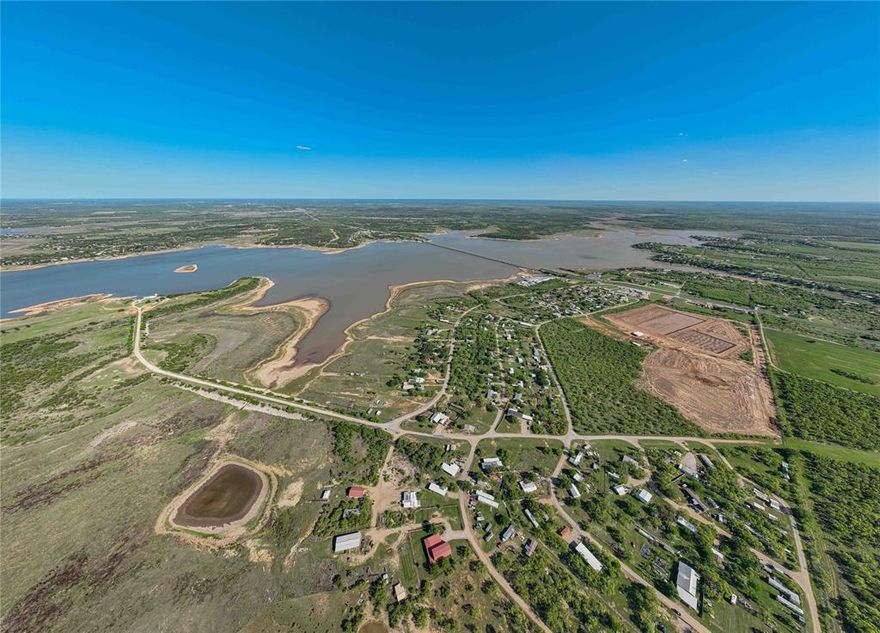 Waterfront opportunity on Hubbard Creek Lake! This .408-acre lot offers a cleared homesite with Ft. Griffin water meter already in place, electric available at the road, and an existing septic system (buyer to verify condition and usability).  The property provides direct access and proximity to the lake, making it an ideal setting for a weekend getaway, fishing retreat, or future homesite. The long, narrow layout offers flexibility for positioning a build while maintaining privacy from neighboring properties.  Located in an established lakeside community with easy road access, this tract combines affordability with the opportunity to enjoy lake living without starting from scratch.  Utilities and site prep are already in place—bring your plans and make it your own.  Affordable waterfront tracts with improvements in place are increasingly hard to find—don’t miss this one.
