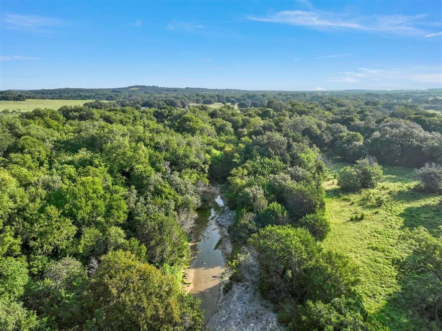 Welcome home to your own slice of Granbury paradise! This 4 acre lot is conveniently located outside the city limits while being only 4.5 miles from the Square. This property boasts no city restrictions and both barndominiums and manufactured homes are allowed. You’ll fall in love with the thick Cedars and established Oak trees dotted throughout the property. The back portion features a beautiful clear live water creek! The property is almost fully fenced, perfect for those with livestock. Located 1 minute away from 377 and less than an hour from Fort Worth, on a beautiful and private feeling street. Enjoy all the peace and quiet of the country while still being in the heart of town and just miles from the lake! The adjoining lot next door, 4303 Ruby Dr. comprised of 4 acres is also for sale. MLS #20693429