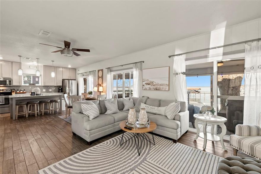 THIS IS THE PERFECT VRBO and AIR BNB READY TO GO! THIS ADORABLE TURNKEY HOME HAS VIEWS FOR MILES WITH THE MOST AMAZING SUNSETS TO SEE FROM YOUR COVERED DECKS SITTING HIGH ABOVE THE WATER.  THIS HOME HAS QUARTZ COUNTERTOPS AND SUBWAY TILE BACKSPLASH IN THE KITCHEN AND MARBLE COUNTERTOPS AND SUBWAY TILE IN BOTH BATHROOMS.  THE FLOORING THROUGHOUT THE HOME IS CERAMIC WOOD GRAIN TILE. NEW WINDOWS AND DOORS WERE ADDED IN 2021, NEW PLUMBING REPLACED WITH PVC AND NEW 38 X 20 DECK ADDED FOR MORE ROOM TO ENJOY THOSE GORGEOUS VIEW, MAKING THIS HOUSE A COMPLETE WORRY FREE LAKE HOUSE! IT'S CLOSE PROXIMITY TO TOWN IS IDEAL BUT FAR ENOUGH AWAY TO REALLY ENJOY THE LAKE LIFE LIVING.