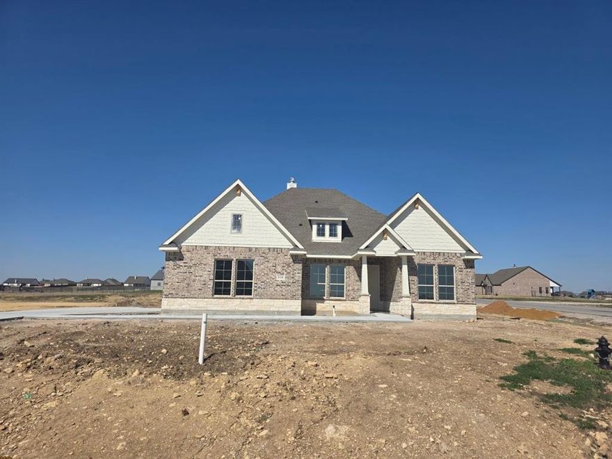 Estimated March 2026 completion! Ask about our Trade In Trade Up program, we can buy your home! The Verbena floor plan features a modern, open-concept layout and the sought-after features today’s homeowners are searching for. With four bedrooms, three bathrooms, and a flex room, this plan boasts just over 2,400 square feet of functional living space. Upon entering the home off the front porch, you’re welcomed by an inviting foyer. Immediately to the left is a hallway with a bedroom, walk-in closet and full bathroom, as well as a linen closet. Across the foyer is a flex room, perfect for a home office, formal dining room or whatever need your family has for the space. Past the foyer is the family entry, with storage space and mud bench, which leads to the laundry room and two or three car attached garage. Through the entrance, the home opens up to a large family room with a stately fireplace. Adjacent to the family room is a gourmet kitchen, equipped with a walk-in pantry, ample counter space and an oversized island. Finishing off this open-concept living area is a dining space which overlooks the covered back patio. The remainder of this one-story floor plan is just off the living space. A hall leads to two bedrooms with walk-in closets, another linen closet and a shared full bathroom. The back corner of the home offers privacy for the owner’s suite, featuring a massive walk-in closet and bathroom with a dual-sink vanity, standalone soaking tub and glass-enclosed shower.