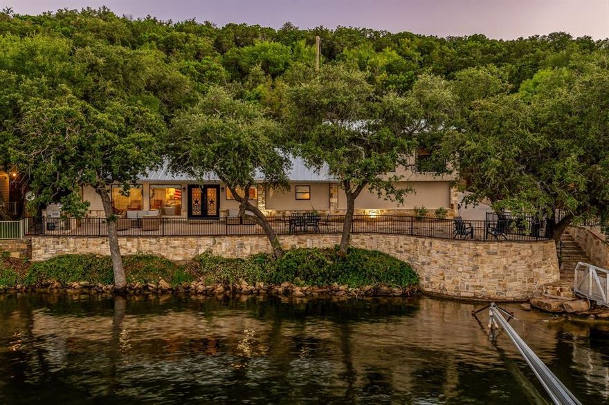 This spacious lake front property in the highly sought after peninsula on PK Lake, provides a tranquil retreat in any season! This gorgeous two-story waterfront retreat features a recently updated deepwater dock with 2 boat slips complete with hydrologist boat lifts and PWC dock. Just miles from Rocker B Ranch, this stunning completely updated home can accommodate up to 20 at one time. Ideal configuration  for both short-term rentals and family escapes.  Enjoy summers swinging from the top of the 2 story dock, fishing off the gangway, or swimming in the quiet waters. Only a short boat ride from the fun at Hell’s gate, or for the scenic views of The Cliffs. In the winter, the views are just as nice, and dinners on the patio from the outdoor kitchen are hard to beat. Memories can be made nestled around the fire pit telling stories, making s’mores and enjoying the starry nights. The four bedroom, two bath home has beautiful views of the lake that can be enjoyed from the fenced back patio or from the floor to ceiling windows of the living room. The home was recently renovated and decorated by the extraordinary Homestyle Collective design team. Offered fully furnished, this property provides a seamless transition into lakeside living or a thriving STR business.