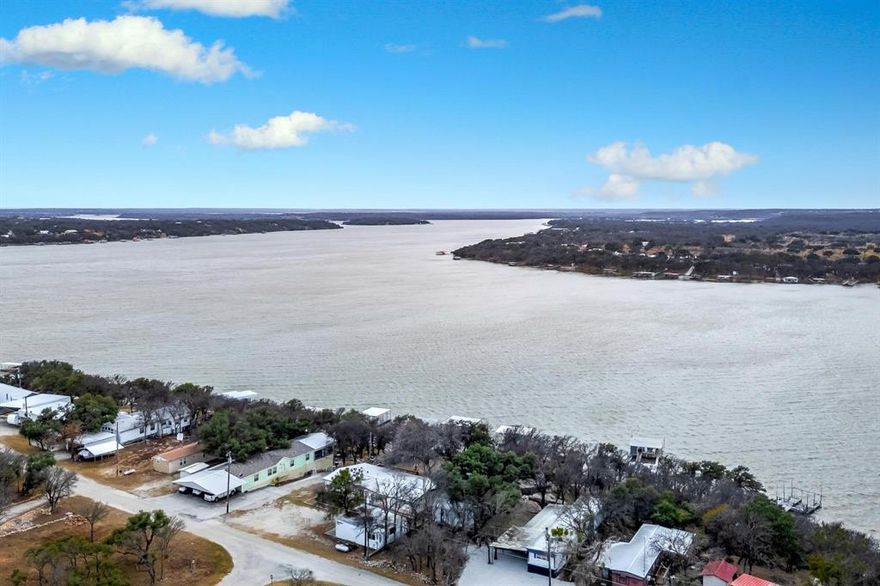 The Lake is calling, answer the call. Charming Lakeside Retreat in Thunderbird Bay. Investors welcome. Approved for short-term rental! Discover your dream getaway at Lake Brownwood without breaking the bank. This charming 3-bedroom, 2-bathroom home is perfectly situated just a block from the serene lake, offering breathtaking views and a lifestyle of tranquility. Featuring a spacious 1592 square feet, this home includes a convenient 2-car carport and a dedicated shop, alongside an RV shed for all your lake toys. The property spans a generous 0.68 acres, ensuring ample outdoor space to enjoy the vibrant wildlife and beautiful trees that surround you. Step inside to find a beautifully updated interior, highlighted by fresh paint throughout, elegant quartz countertops, and real wood cabinets. The remodeled guest bathroom adds a touch of luxury, while the LG gas stove is perfect for culinary enthusiasts. Enjoy the fruits of your labor with pecans, apricots, and peaches from your own trees. Storage is abundant with spacious walk-in closets, a dedicated arts and crafts room, and multiple options to keep your possessions organized. The shop is equipped with water, electric, and an air compressor and tank, making it a versatile space for all your needs. As part of a friendly lake community, you’ll have access to private docks, a community swimming pool, and a playground, ensuring fun for the whole family. This property is the ideal escape for those seeking a peaceful lakeside lifestyle or an investment opportunity as an Airbnb. Don’t miss out on this chance to own a slice of paradise at Lake Brownwood!