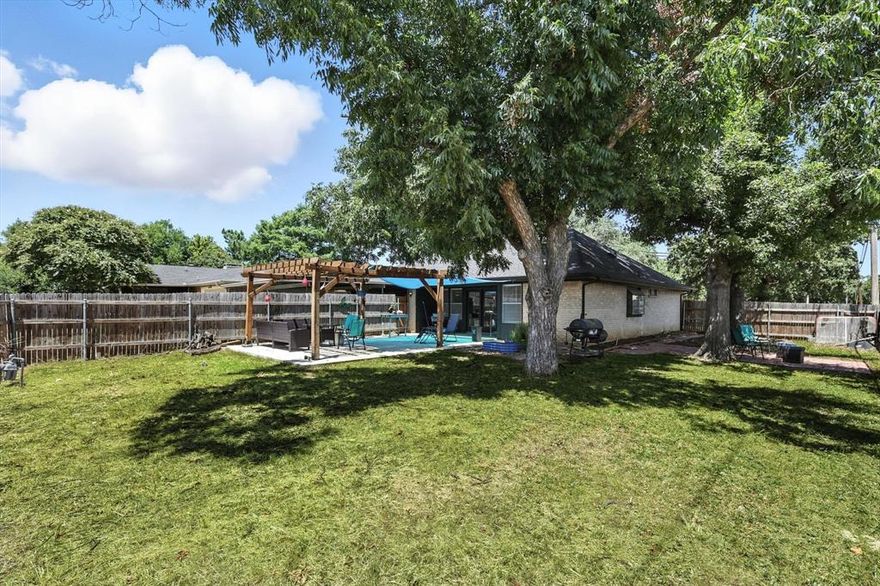 *** SELLERS CONSESSIONS OF $5,000 OFFERED!!*** Welcome to this gorgeous neighborhood! Terrific 3 bedroom and 2 bath home with a 2 car garage is now on the market in Lewisville. This home offers outdoor entertaining space, unparalleled. You’ll enjoy preparing meals in the gorgeous kitchen with sleek granite counters, tiled backsplash, stainless appliances, and beautiful spacious white cabinetry. Flow into the living room featuring a cozy fireplace, perfect for entertaining. Homes updated, beautiful interior with vaulted ceilings, vinyl floors throughout, plenty of natural light, and neutral palette. The main bedroom boasts a private ensuite bathroom with tiled shower and closet. Other bedrooms offer ceiling fans and sizable closets. Relax with your favorite drink in the fenced in backyard with 2 seperate seating areas, a HUGE extended patio, pergola and sunshade.