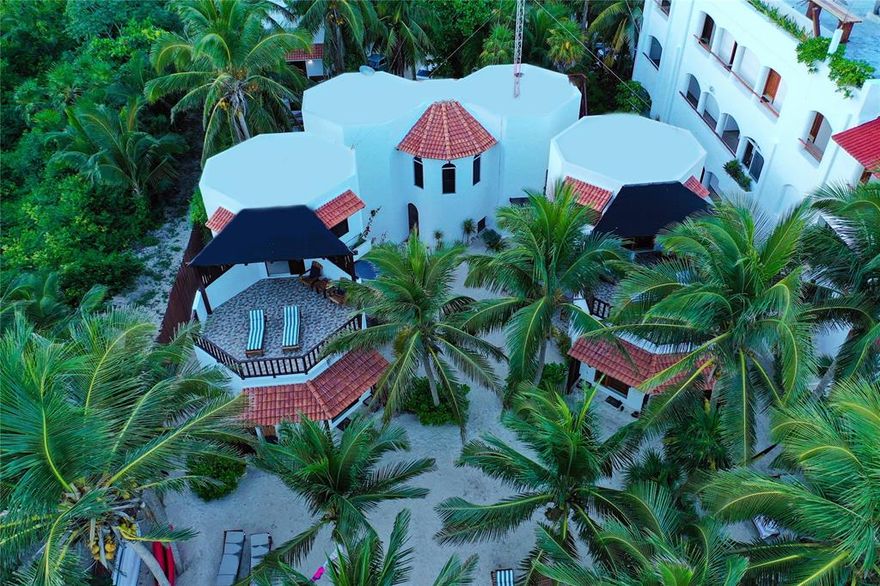 CARIBBEAN SEA BREEZES AND SUGAR WHITE SAND IN WORLD-FAMOUS TULUM, MEXICO await a new investor or resident owner of the famous CASA COLIBRI TANKAH - THE JEWEL OF TANKAH!. Located directly on the shoreline of the Caribbean Sea in Tankah Bay, this successful income-producing property of 6 short term rental units and a 2 BR, 3 BTH main house is already established as a guest favorite on Air BnB, Booking.com, TripAdvisor, and CasaColibriTulum.com - read the 5 star reviews. One guest stated that, *you fall out of your bed and into the ocean*.  A true beach-front paradise with white-washed walls and tile-roofed casitas that feature natural, locally sourced materials and furniture. Palm tress sway in the breeze, while sea turtles lay eggs in the soft sand, and guests melt away their city stress swinging in a hammock or lounging by the sea. The established business, furniture, and all appliances convey, excluding owner's items. Sellers are original owners and have all records, blue prints, financials, etc. for serious inquiries. Permitted room for expansion - main house can be converted to two units and building code will allow a third floor on all structures. A dock is also permitted. Nature abounds with a park and fresh water cenote across the street on the west side and the protected bay next to the sea in the back on the east side. A vacant lot is on the south side. Gated, guarded entrance to the exclusive area and neighborhood restaurant and businesses add to guests' positive experience. Gated parking for up to 7 vehicles on the property. 1 hour from Tulum International Airport; 20 minutes from downtown Tulum; 11 minutes from Tulum Ruins. Owning Casa Colibri Tankah is an exceptional opportunity to diversify a real estate portfolio, or take the plunge into resort management in the Maya Riviera of Mexico's famed Caribbean Sea. Wedding venue, yoga retreat, conference location - Casa Colibri Tankah is versatile and waiting for your imaginative touch!