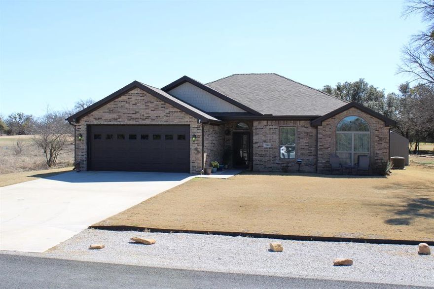 Always wanted to live on the golf course. Here is your chance. 1948 sq ft 3br 2 ba home on the 10th hole of the Hideout Golf Course and Resort at Lake Brownwood. Step into a breath of fresh air with open concept living room and kitchen. The kitchen has granite counter tops, custom wood cabinets, stainless steel appliances, and of course a pantry. The dining room sits off the kitchen with a view of the golf course. The master bedroom has trayed ceilings with a ceiling fan and carpet. The master bath has his and her sinks, separate shower and tub, wrap around walk in closet, and a surprise in the toilet room. On demand water heater in the garage, attic access in the utility room, 30 year shingles with rain gutters.  Sprinkler system to ensure even watering on the Bermuda grass. Sit on the back porch under the extended roof and listen to the golfers with their niceties as they tee off. Only ten to fifteen minutes to Brownwood. See the Hideout's website for current amenities.