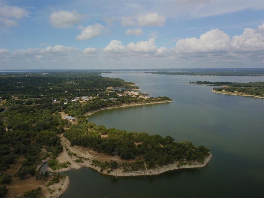 Build your dream home or purchase a lot at White Bluff Resort, just 1.5 hours from DFW or Waco. Enjoy amenities like golf, fishing, hiking, pools, lake access, parks, and catch-and-release ponds. Membership includes rounds on two golf courses, access to four pools, tennis courts, restaurants, a marina, boat ramps, cabins, condos, and a hotel—all in a scenic community with abundant wildlife.
