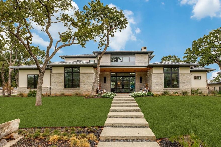 Welcome to an exceptional custom-built residence situated on one of the highest elevations in Grapevine, TX. This stunning home offers the perfect blend of luxury, functionality, & privacy all within a gated private compound shared with one other property. Designed for seamless single-story living this home features an open-concept layout that connects the expansive living & dining areas to a dream kitchen. The large living area has a soaring ceiling with a beautiful stone fireplace, amazing natural light & overlooks the rich amenity backyard. Upstairs, a family room opens to a sprawling outdoor terrace with elevated views of the backyard. The dream kitchen has a large central island—ideal for entertaining and is outfitted with premium appliances, adjacent to an oversized butler’s pantry perfect as a prep kitchen for entertaining.  The lovely primary bedroom suite has an oversized ensuite bath with his & her walk-in closets. There are 3 spacious bedrooms each with their own ensuite bath. There are 2 additional half baths in the home. Additional interior highlights include a generous utility room, mud room, and dedicated dog room with access to a fenced dog run—perfect for pet lovers. The home includes a 4-car garage with custom glass doors & ample storage. Outdoors, enjoy resort-style amenities including a covered living & dining area perfect for family gatherings.  The dining area has a fireplace & built-in grilling station. In addition, both the living & dining areas have electric retractable screens, Bromic heating panels, and a high-end misting system accompanied by an outdoor sound system—ensuring year-round comfort. The list of amenities is topped off with a sizeable heated swimming pool & spa, modern water feature & six Tucci Umbrellas for comfy shade in the Texas sun. With its private gated entry, breathtaking elevation, expansive grounds & thoughtfully designed spaces both inside & out, this one-of-a-kind property is truly a rare find in Grapevine.