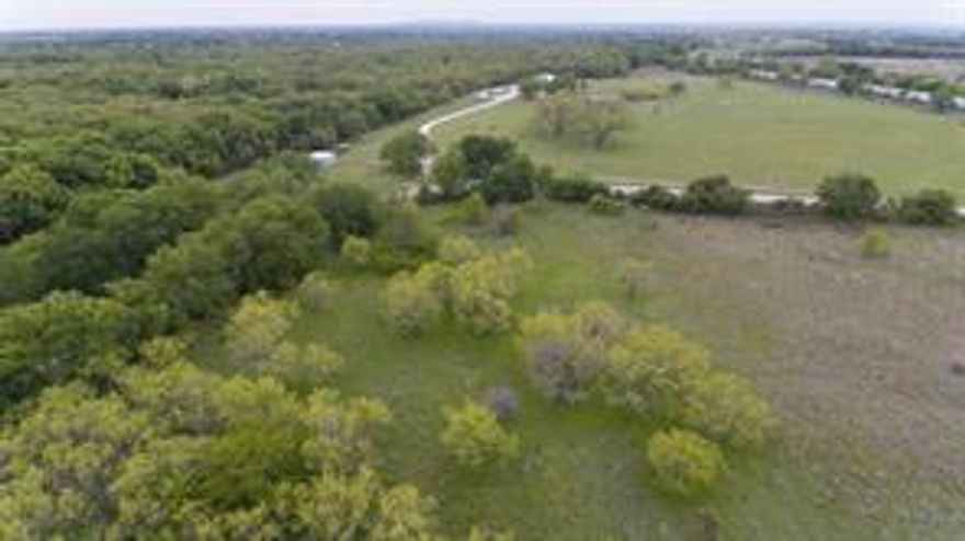 38+ Acres on M&M Ranch Rd. Located on the Fort Worth side of town this property is gated, fenced, and offers beautiful mature trees with an abundance of wildlife. Ideal for any number of uses including but not limited to the site of your new dream home, commercial or industrial, farming, pasture land or subdivide it and build some spec homes.  Located outside the city limits there are no zoning requirements or deed restrictions.  The property has a cattle guard at the entrance so it is ready for livestock.  Well and septic required. PROPERTY IS LEASED TO HUNTERS DO NOT ENTER WITHOUT A CONFIRMED APPOINTMENT