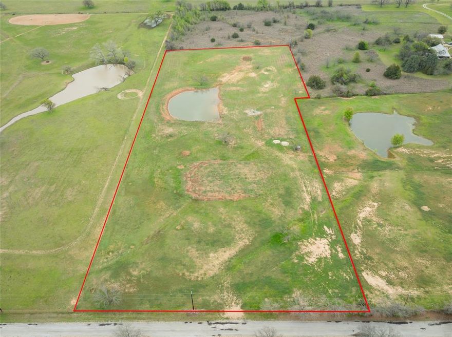 Six acres of serene county land, offering a picturesque blend of fields and woodlands. Perfect for a variety of purposes, from building your dream home to cultivating a small farm. Embrace the tranquility and potential of rural living on this spacious property. This property has a well maintained pond, 175X120 house pad, 40X80 shop pad along with many opportunities. This land would make the perfect place to build your dream home. This land is 6.093 acres. This property has a water meter and is ready to go! Call or text agent for a showing today!
