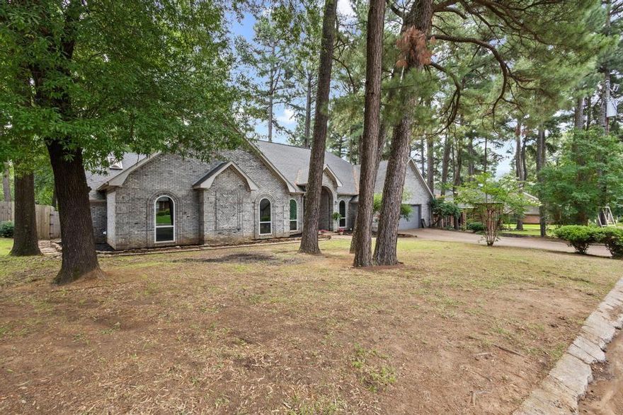 This house has everything you not only need in a home but want as well, with just enough character to make it stand out. Great curb appeal, surrounded by tall pine trees. It’s a 3 bed, 2.5 bath brick home with an attached two-car garage sitting on just over a quarter acre. The layout is split, a massive primary bedroom and large primary bath on one side, and two bedrooms with a Jack-and-Jill bath on the other.

There’s a large laundry room with storage, a sink, and a there is a half bath for guests. The living room has big bay windows looking out to the backyard. The kitchen has tons of cabinet and counter space, a pantry, and a big island that opens into a den with 15 foot ceilings and skylights. Off to the side is a dining nook with views of the pines out back.

Tall ceilings, hardwood floors, with a recent water heater and window updates. Outside is a private, fully fenced backyard with a huge deck, perfect for enjoying the shade of the pine trees in the evenings, with a 10x14 storage shed.

Great house, great features, great price. Let’s get you into Pine Valley.