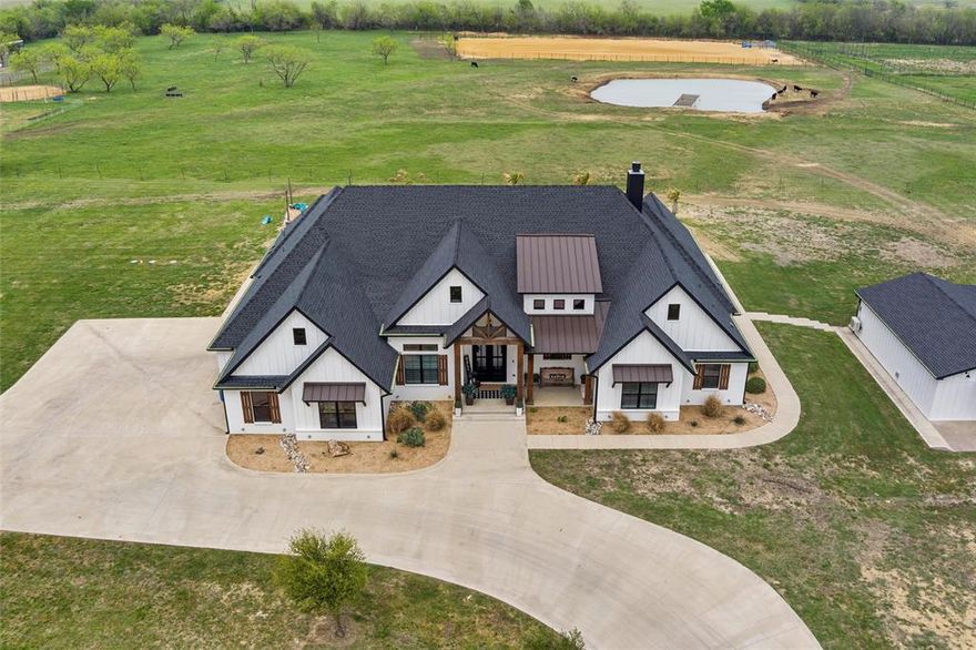 Welcome to a one-of-a-kind estate where luxury meets country charm on over 15 pristine acres in the heart of Maypearl. This custom modern farmhouse is packed with high-end finishes and thoughtful features, designed for both comfort and functionality.

The main home features ensuite bathrooms in every bedroom, giving each family member or guest their own private retreat. Soaring ceilings with exposed wood beams, a stunning stone fireplace, and expansive windows flood the living spaces with natural light and countryside views. The gourmet kitchen is a showstopper with Wolfe brand appliances, commercial-grade Sub-Zero Wolf refrigeration, and a massive island perfect for gathering and entertaining.

Step outside to find a fully fenced and cross-fenced property, ideal for livestock or equestrian use. You’ll also love the resort-style pool and spa, and a spacious covered patio that’s ready for entertaining or relaxing with sunset views.

But that's not all—this property includes an incredible barndominium featuring 2 bedrooms, 1 full bath, a full kitchen with granite countertops, and a cozy living area. Perfect for guests, in-laws, or rental potential.

Looking for a space to unwind or entertain? You’ll also find a detached game room complete with a built-in man cave—the ultimate bonus space! The home features a 10 stall barn with an extra apartment and bathroom. Also features a riding arena and pond. 

This property truly has it all: luxury, space, privacy, and versatility—just 45 minutes from DFW. Come experience what ranch living should feel like.