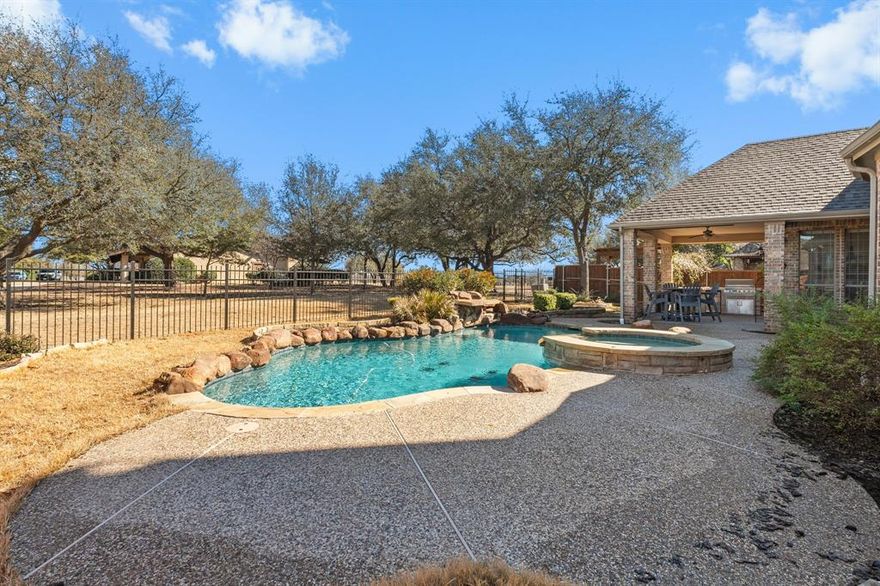 Stunning Highland home with sparkling pool and spa in sought after Lacima subdivision of Stonebridge Ranch. Imagine coffee on your front porch every morning and cooking with friends on the back porch in the early evening. Premium greenbelt lot with panoramic views, built in outdoor cooking area, pool and spa, and waterfall on almost a quarter of an acre.  This lovely home has 5 full bedrooms with primary and full guest suite located downstairs.  Popular floorplan with spacious chefs kitchen with double ovens, large island, a butlers pantry, large walk in pantry and gas cooktop. Hardwood floors through the entertaining spaces downstairs. 4 living areas including a formal living room, family room, gameroom and media room.  Downstairs living space has a beautiful stone fireplace and custom built in with view of the pool and spa.  Primary bedroom has a sitting area overlooking the greenbelt. AMAZING primary bathroom has been completely remodeled. Your private RETREAT awaits ! Stonebridge amenities include beach lagoon pool, splash pad,  tennis and pickleball, basketball courts, parks, walking trails and ponds. 2 AC units replaced 2021 and water heater converted to tankless in 2020. Several rooms recently painted and all upstairs carpet replaced.