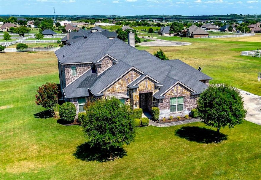 Welcome to your perfect retreat, a well maintained home offering the peace and privacy of country living with the convenience of Fort Worth and Granbury just minutes away. 105 Legacy Downs welcomes you home with rich features such as beautiful hardwood floors and arched doorways, plus an easy flowing floorplan and outdoor living space that make relaxing and entertaining a breeze.

Sitting on just over an acre, your yard is the perfect spot for anything from corn hole to football. Enjoy a quiet morning coffee on the expansive covered back porch and in the evening entertain friends and family with plenty of space for everyone. End your day with incredible stargazing in the country skies. 

The openness of this elegant home makes it perfect for entertaining. The kitchen is spacious with granite countertops and it leads into a dining area with ample views of the back yard. The large living area has rich hardwood floors and a stone fireplace that are cozy and welcoming. 

Downstairs, you’ll find the primary suite which offers plenty of room, privacy, and an ensuite. The guest suite is also downstairs and has its own full bath. The study is a perfect place for your home office, library, or music room. Upstairs offers a large game room with two bedrooms and a full bath. 

Your vehicles are at home in the two car garage and an additional garage is perfect for your mower, tools, bicycles, sports equipment, or extra storage.  

Legacy Pointe neighborhood offers highly rated Aledo schools plus seasonal activities such as Boo Bash for Halloween and a special visit from Santa via the Cresson Fire Department. Enjoy lake time as Lake Granbury and Lake Benbrook are both nearby.
This home blends comfort, elegance, and functionality all in one while its location offers the best of both country living and city convenience. Come see for yourself what makes this one so special.