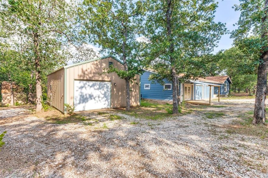 This 1.63 acre  (per tax) retreat blends timeless charm with modern upgrades. The build-in phone niche, mail slot, mural sunroom, are certainly conversation pieces.  Discover the remodeled home with a stunning kitchen, granite countertops, hickory soft touch cabinets, custom pantry with pull out drawers, black stainless steel appliances, gas cooking and farm sink. The wood flooring is beautiful and you will find them in the family room and bedrooms.  Relax in the luxurious tile shower with glass enclosure and seat.  Car enthusiast and hobbyists will appreciate the expansive workshop capable of accommodating three cars, providing ample space for projects and storage.  Additionally the two-car garage offers added convenience and protection for your vehicles.   Embrace county living surrounded by trees but convenient to highway access, Chrishom Trail.   Schedule a visit and envision a refined life in this country retreat.