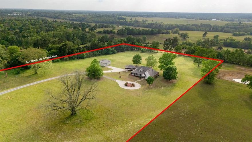 Architectural artistry, character & substance are found in this 4BR-3BA timeless classic home. It's quality built of stone, brick &concrete based siding. Surrounded by improved hay meadow, it's located 3 miles north of Winnsboro. The gravel & concrete drive welcomes you. Embellished with easy care established landscaping, circular round-about, & flagstone walkways create an impressive drive-up experience. Enter the elegant front door to a foyer that grants access to a staircase to the 2nd floor, spacious family-dining room, guest room and bath, or the kitchen-breakfast room. Gleaming hardwood floors and beaded ceiling highlights the living area graced by the stone fireplace . The large primary bedroom has en suite bath with shower & soaking tub, custom cabinets , tile floor & private toilet area. Kitchen also has tile floors & rich golden oak cupboards & built-ins. The efficient step saving kitchen is abundant with storage. The all electric smooth cooktop, built-in microwave, & double ovens will please the family chef. Laundry room is off the kitchen, and home has 2 central HVAC units. Carport has a storeroom that is plumbed for an additional bath, but is not finished. The large metal shop has 2 walk through doors, plus an overhead door for vehicles, boat, outside equipment, tools, hobbies, and handicrafts. All this on 11.2 acres, but additional land available. Move-in ready for your quiet use & enjoyment of pastoral views & close-by conveniences. Just a short distance to the inviting, thriving small city of Winnsboro, Texas, home of The Autumn Trails. There are nearby lakes for Fishing & watersports. You'll find excellent schools, downtown shops, restaurants & places of Worship. Come for a visit &stay for a lifetime. Welcome home!