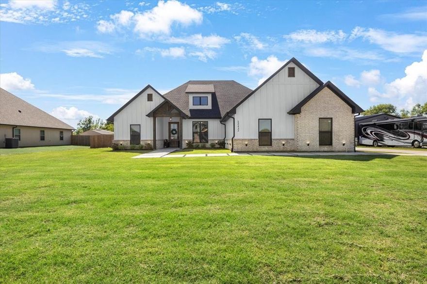 Welcome to this beautifully crafted 2,229 sq ft home that feels like new and is packed with upscale features and custom finishes. Situated on a generous .68 acre lot, this property offers both space and style in a peaceful, scenic setting. The open concept living area showcases a breathtaking floor to ceiling electric fireplace perfect for cozy evenings and elegant entertaining. A walk-in dining room with an eye-catching accent wall adds personality and charm. The kitchen is a true centerpiece, featuring a sophisticated mix of white cabinetry, black accents, and light wood tones for a bold, modern look. Enjoy a split floor plan for added privacy, with luxury vinyl plank flooring in all bedrooms and durable tile throughout the main living areas. Every detail of this home reflects thoughtful design and quality craftsmanship. Don't miss your chance to own this move-in-ready gem with over half an acre to spread out, perfect for enjoying outdoor living with room to add a shop, pool, or garden oasis.