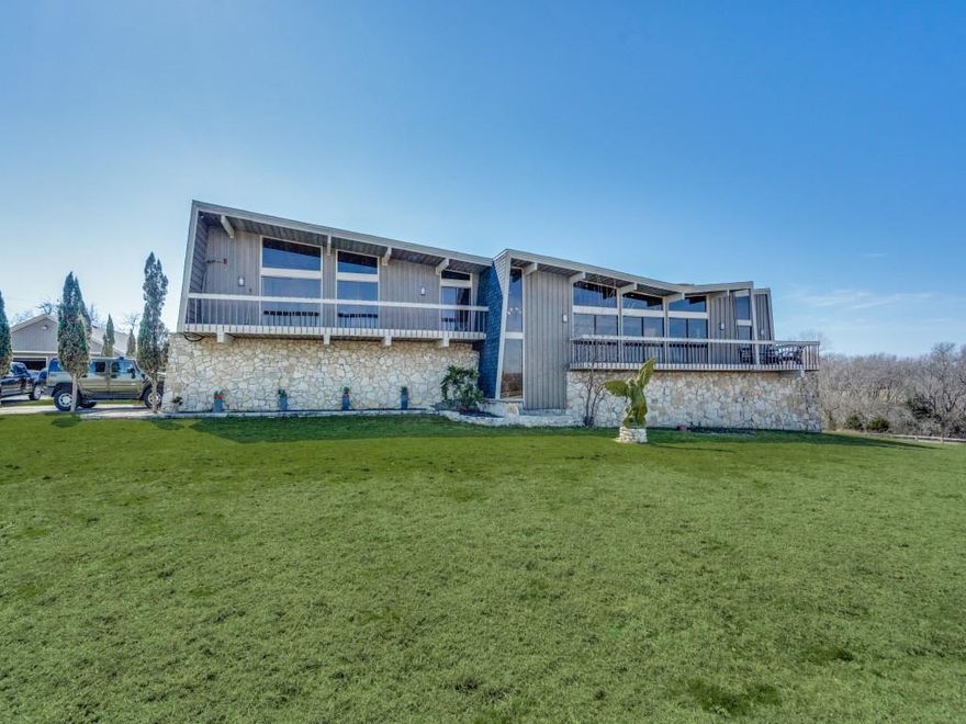 24 acres in sought after Lovejoy School district.  Rolling Hills, lake view, gated entry, Hilltop views.  Great investment opportunity or your own private piece of heaven in Lucas.  Home is extremely special.  Tri level.  Frank Lloyd Wright style design. 4 bedrooms, Two living areas, Game and Media Rooms. Private office.  Open floor plan. Wonderful large floor to ceiling Windows with amazing views and sunsets. Unique woodwork throughout.  Two car attached garage along with another large shop and garage for additional parking.  Mother in law suite on ground level. Many balconies and covered porches.  Outdoor entertainment with build in kitchen and fireplace.  All overlooking Seis Lagos Lake.  Additional Land available as well, ask agent for details.  This property would also make for a great investment for subdivision see info under transaction desk.