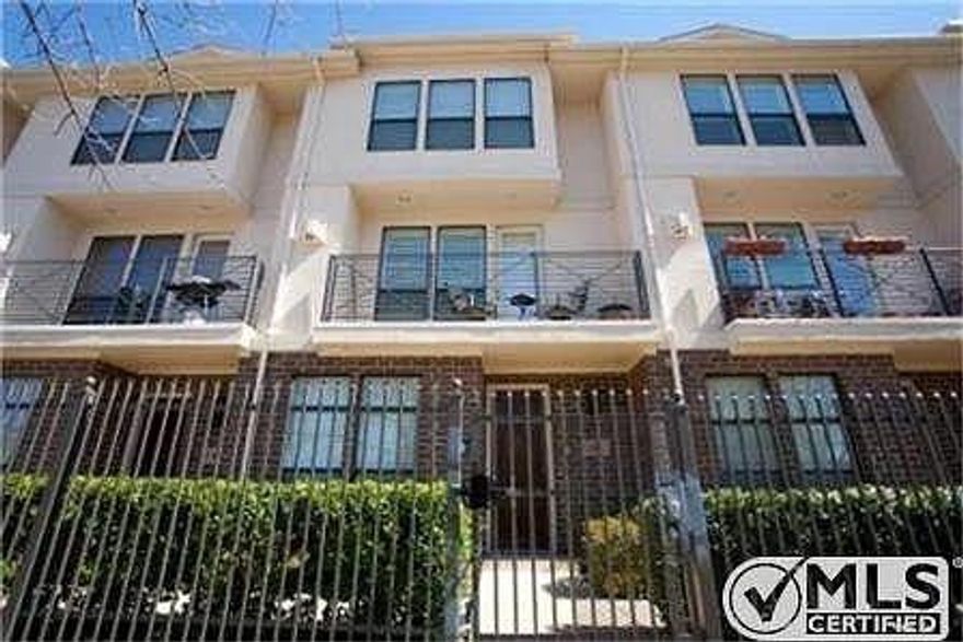 Upgraded 2-bed, 2.5-bath Uptown townhome offering walkability, smart-home features, and great entertaining space. First floor includes a private guest suite with full bath and walk-in closet, plus rare oversized under-stairs storage and direct access to a 2-car garage with dual EV chargers and extra storage. Second floor features a bright open-concept layout with oversized windows, chef’s kitchen with large island, pantry, and custom wet bar, plus dining-living area anchored by a gas fireplace, half bath, and balcony. Third floor offers a spacious primary suite with two walk-in closets and ensuite bath (dual sinks, large shower, jacuzzi tub), a large landing ideal for office or nook, and a washer-dryer closet. Enjoy an expansive third-floor balcony with room for seating and dining. Smart systems include Philips Hue lighting(doorbell camera, alarm, motion sensors, remote garage, leak sensors). HOA covers water; large lot across the street adds convenient guest parking.