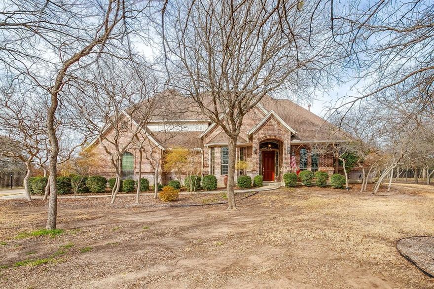 Situated on just over an acre in Covered Bridge Canyon this 5 Bedroom, 3 and a half bath custom home exudes timeless style, quality craftsmanship and elevated finishes. Classic brick exterior opens to warm hardwood floors, crown molding and walls of windows throughout - all overlooking the sparkling pool and expansive backyard. Exceptional floorplan features 2 Living spaces, 2 Dining areas, an office, powder bath and THREE bedrooms all on the FIRST FLOOR-ideal for large families, guests or multigenerational living. Enjoy cooking in this stunning kitchen complete with painted cabinets, granite counters, NEW appliances, LARGE walk in pantry and updated lighting! Serene primary retreat with tray ceiling, crown molding, dual vanities, jetted bathtub, walk in closet and lots of windows with plantation shutters-so pretty! The two bedrooms downstairs each have their own vanity and adjoining bath. UPSTAIRS-Two generously sized bedrooms with HUGE WALK IN CLOSETS and hall bathroom. Experience your own private oasis in the backyard! Magnificent pool and spa, outdoor living space with kitchen and pergola so you can entertain all year! Oversize 3 car garage with plenty of room for cars, trucks, toys, deep freezer and refrigerator! ALEDO SCHOOLS! Do not miss the FULLY DECKED ATTIC and Storm Shelter! Meticulously maintained and lots of UPDATES! See TD for MORE!