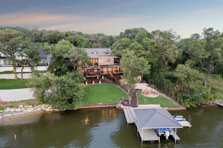 Opportunities like this don’t come around often—this is truly a rare piece of lakefront paradise! Located on the shores of Moss Lake in Gainesville, Texas—where custom design, natural beauty, and lakeside living come together in perfect harmony. This one-of-a-kind home offers 5 bedrooms, 4 full bathrooms, and an expansive 3,092 square feet of living space. With the ability to sleep up to 18 guests, it’s the ultimate destination for hosting holidays or weekend getaways. From the moment you walk through the front door, you’re greeted by a breathtaking great room that stretches the full length of the home—over 50 feet—framed by soaring vaulted wood ceilings, exposed beams and rich Hickory wood flooring throughout. A stunning floor-to-ceiling stone fireplace anchors the living area, while a full wall of picture windows draws your gaze to panoramic lake views. The gourmet kitchen features stainless steel appliances, including a 6-burner gas cooktop, granite countertops, custom cabinetry, a stone backsplash, and an oversized island perfect for prepping meals or serving a holiday feast. The layout of the home was intentionally designed for both privacy and function. The main floor includes the primary suite along with a guest bedroom, while the lower level houses three additional bedrooms and two full bathrooms. Each lower-level bedroom features pine flooring, sliding glass doors, and access to the expansive lower deck. Step outside and you’ll discover multiple outdoor living areas spread across four tiered deck levels. Enjoy fireside evenings with two separate fire pits—one just steps from the front porch and another perfectly positioned lakeside for s’mores, storytelling, and stargazing. At the shoreline, an oversized dock awaits with a boat lift and an attached twin floating jet-ski dock. Moss Lake itself is a closely guarded North Texas secret—quiet, wildlife-rich, and just 60 miles from DFW and 16 miles from WinStar World Casino.