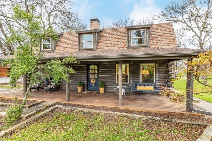 Have you ever dreamed of owning your own log cabin retreat? Now is your chance to make that dream a reality! Located within walking distance of beautiful Benbrook Lake, this stunning cabin sits on just under 1.5 private acres and has been completely renovated down to the studs with high-end finishes throughout.
Notice the fabulous light fixture above the staircase as you enter the home.  The gourmet chef’s kitchen features a built-in refrigerator and freezer and luxury high-end Monogram GE appliances along with a six burner gas stove.  The original pine wood floors have been beautifully refinished to preserve the home’s rustic charm. A gorgeous stone fireplace anchors the family room, creating the perfect space to relax on cool mornings or cozy evenings. Thoughtful renovations maximize storage throughout the home, utilizing every inch of space.  There are 2 Generac generations installed in the home so you never lose electricity along with a tankless hot water heater.
Step outside to enjoy peaceful mornings on the patio overlooking your private acreage and the stillness of nature. The pool has recently been updated with new decking and equipment and is ready for summer enjoyment.
Additional highlights include a newly replaced well, an oversized two-car garage with ample storage, and a versatile workshop that’s approximately 1400 square feet ideal for projects or hobbies. The workshop also features a storm room for added safety, along with covered space for boat or jet ski storage—perfect for taking advantage of nearby lake recreation.
Whether you’re looking for a weekend getaway or a full-time escape from city life, this one-of-a-kind property offers the perfect blend of privacy, comfort, and convenience. Don’t miss this rare opportunity—this gem won’t last long!