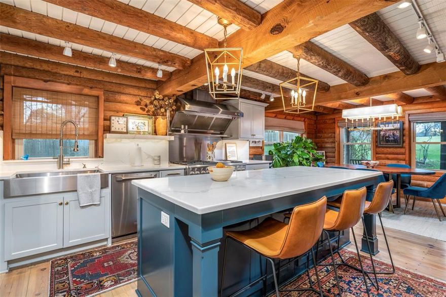 Have you ever dreamed of owning your own log cabin retreat? Now is your chance to make that dream a reality! Located within walking distance of beautiful Benbrook Lake, this stunning cabin sits on just under 1.5 private acres and has been completely renovated down to the studs with high-end finishes throughout.
Notice the fabulous light fixture above the staircase as you enter the home.  The gourmet chef’s kitchen features a built-in refrigerator and freezer and luxury high-end Monogram GE appliances along with a six burner gas stove.  The original pine wood floors have been beautifully refinished to preserve the home’s rustic charm. A gorgeous stone fireplace anchors the family room, creating the perfect space to relax on cool mornings or cozy evenings. Thoughtful renovations maximize storage throughout the home, utilizing every inch of space.  There are 2 Generac generations installed in the home so you never lose electricity along with a tankless hot water heater.
Step outside to enjoy peaceful mornings on the patio overlooking your private acreage and the stillness of nature. The pool has recently been updated with new decking and equipment and is ready for summer enjoyment.
Additional highlights include a newly replaced well, an oversized two-car garage with ample storage, and a versatile workshop that’s approximately 1400 square feet ideal for projects or hobbies. The workshop also features a storm room for added safety, along with covered space for boat or jet ski storage—perfect for taking advantage of nearby lake recreation.
Whether you’re looking for a weekend getaway or a full-time escape from city life, this one-of-a-kind property offers the perfect blend of privacy, comfort, and convenience. Don’t miss this rare opportunity—this gem won’t last long!