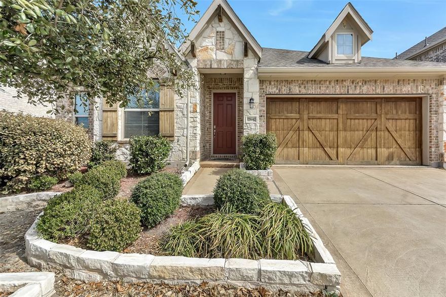 Welcome to this beautifully maintained single-story 4-bedroom, 2-bath home in the highly sought-after University Place, zoned to acclaimed Plano ISD. Built in 2017, this home combines modern design with warm, timeless finishes and an exceptional floor plan. Step inside to high vaulted ceilings, abundant natural light, and a warm modern color palette that creates an inviting atmosphere throughout. Hardwood flooring extends through the main living areas and all bedrooms, adding elegance and continuity. The open-concept kitchen is a true showstopper, featuring granite countertops, abundant cabinetry, stainless steel appliances, gas cook-top, and a farmhouse sink. The oversized island provides generous prep space and seating, making it ideal for entertaining and everyday living. The kitchen flows seamlessly into the spacious living area highlighted by a beautiful cast stone fireplace. The private primary suite offers a peaceful retreat with an en-suite bath featuring a huge walk-in shower and dual sinks creating a spa-like experience at home. Three additional bedrooms provide flexibility for guests, a home office, or playroom. Step outside to enjoy the extended covered back patio complete with a ceiling fan, ideal for relaxing year-round. The large backyard features lush landscaping and attractive stone landscape borders, offering both beauty and functionality. The east-facing backyard is especially desirable, keeping the space comfortable and enjoyable for most of the day as the afternoon sun remains on the front side of the home. Residents of University Place enjoy tons of community amenities including a resort-style pool, gym, scenic pond, walking trails, parks, and a fenced dog park. With its desirable single-story layout, modern upgrades, spacious yard, and unbeatable location, this move-in ready home truly has it all!