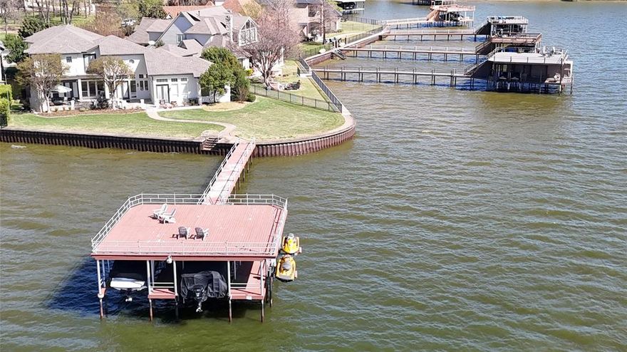 Experience the ultimate lakefront lifestyle in this sprawling open-water estate on Cedar Creek Lake, perfectly positioned just 75 minutes from Downtown Dallas. Designed for effortless entertaining and multi-generational living, this rare 6-bedroom, 5-bathroom residence offers the space and luxury required for large-scale hosting or peaceful family retreats.
The expansive floor plan features three distinct living areas, two fully equipped kitchens, and a private elevator for easy accessibility. Whether you are hosting a summer soirée or a quiet weekend, the home provides dedicated spaces for everyone, including a professional media room, a large gameroom, and a private home office. The current owners have cherished the home’s ability to comfortably accommodate three full families simultaneously, making it a true legacy property for children and grandchildren alike.
Outdoor living is the centerpiece of this estate. Enjoy spectacular views from the massive patio or head down to the premier boathouse, which is fully equipped to house two boats and two personal watercraft. Situated on a prime stretch of open water, the property boasts a unique and picturesque vantage point directly across from the 15th tee of the prestigious Pinnacle Club Golf Course.
From high-energy water sports to serene sunsets over the greens, this home offers an unparalleled lake experience. Don’t miss the opportunity to own a premier piece of Cedar Creek Lake real estate.
The owners are also willing to negotiate the sale of all furnishings, boats, and watercraft, making this an instantly useable lake house for your family with all the amenities ready to go!
Boat house is 30'X30', patio is 20'X44'.  Property has approximately 166' of lakefront, which is rare.