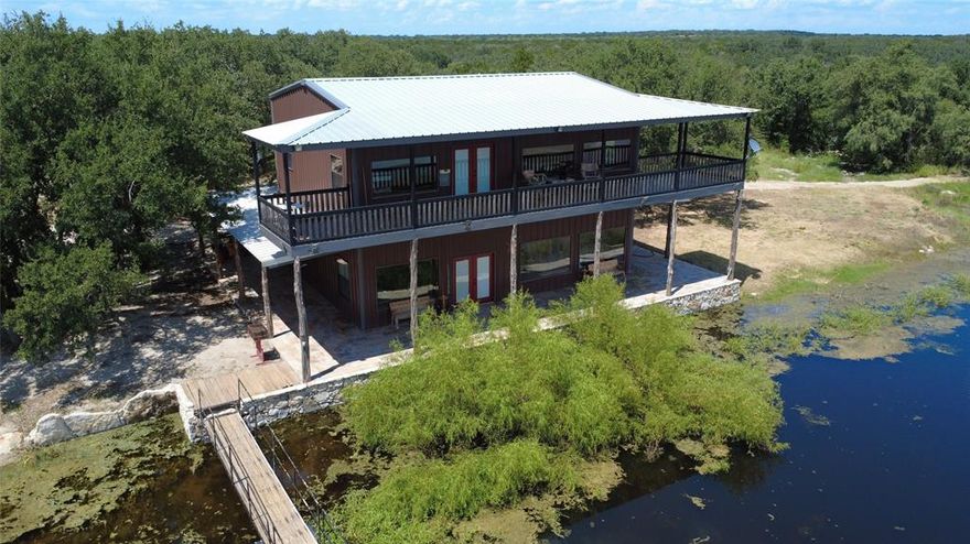 Top tier 266 acre property featuring a 2400sqft custom built Main House sitting right at the edge of a stocked 5 acre lake. The second story of the Main House is a 1200 sqft master suite with a balcony that runs the length of the house, overlooking your private scenic lake.  A pier runs from the back portion of the wrap around covered porch straight down to the dock. Additionally, there is a 1456sqft manufactured home with a metal shop building next to it, as well as a small 336sqft cabin. Trails run throughout this property. Take a walk from the Main House around the edge of the lake and explore vast acreage with varied tree coverage, elevations and wildlife. In addition to the main lake, there are 2 stock tanks, excellent for wildlife and livestock. Excellent hunting including white tail, turkey and dove. The lake is stocked with Catfish, Bass, Crappie and Perch. Great fishing is just a short walk out the back door. The three houses are spaced apart nicely to allow for privacy when you bring the in-laws. However, they are still connected via trails on the property so that you can visit with just a short ride on an ATV or golf cart. Around the Main House and the Small Cabin there are 3 locations with RV hookups. 

This property could serve so many functions or fulfill so many visions. A ranch to retire on, a dream vacation destination during the summers and hunting season or a corporate retreat.