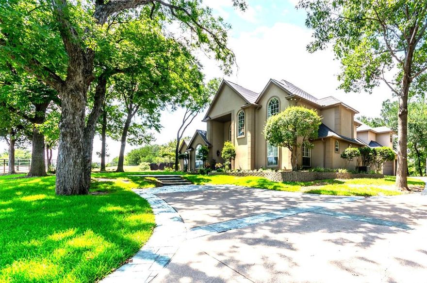 Argyle ISD, 6 Acres, Ag Exempt, gated entry and idyllic country living with 2 barns, extended concrete parking, water well, pipe on pipe fencing, property is bordered by creeks on 2 sides.  This home has hand scraped hardwood floors, granite and quartz countertops, separate ice maker, instant hot water dispenser, 2023 refrigerator.  There are animal stalls and poultry coops.  4 bedrooms with an office that could be a 5th bedroom.  The oversized 3 car garage has an air conditioned workshop.  Heated pool and spa with smart lighting system and timers you can control from your smart phone.  The yard around the house has a full sprinkler system.  FIOS internet.