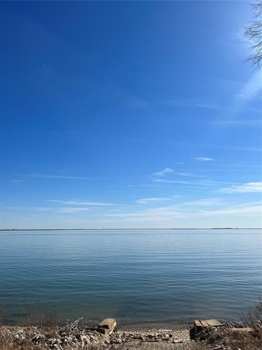 Three build sites on four acres! The largest expansion of open water facing south with stunning views from almost every angle. Sunrise and moonrise to sunset, including southern breezes and the lights of Downtown Dallas at night. Huge oaks, gated entrance, ramp, additional buildings and tennis court recently resurfaced, no HOA. Only property like it on Lake Lewisville! Simply Amazing!!