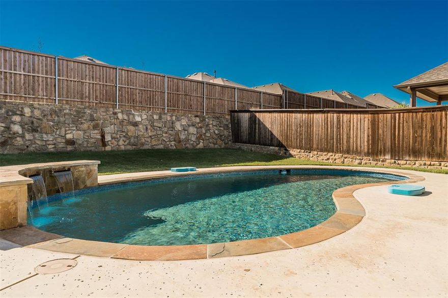 A hidden treasure awaits in the coveted High Pointe Addition in Birdville ISD!  This stunning KHovnanian built home boasts a waterfall custom-built pool on an oversized lot offering a resort like lifestyle.  Privacy, a covered patio, extended flatwork, and a large grassy area to boot will allow for fun filled entertaining evenings while enjoying the beautiful Texas sunsets.  Dinner will be a magical nightly event in the gourmet kitchen offering stainless steel appliances, a spacious kitchen island, beautiful quartz countertops, cabinets for days, a walk-in pantry, and a farmers sink.  Cozy up to a wonderful movie with loved ones in the peaceful living area, or glide upstairs for a game room experience to top off any day.  Let the stress of the day melt away in the private owner's suite or slip into luxury in the ensuite spa like bath, complete with dual sinks, an oversized enclosed shower, and a massive closet complete with windows.  3 upstairs guest bedrooms offer privacy with a large guest bath.  Withing walking distance to Haltom High School, easy access to freeways, shopping and entertainment just minutes away.  Need furniture?  Furniture included if desired.  Your new lifestyle awaits...welcome home!