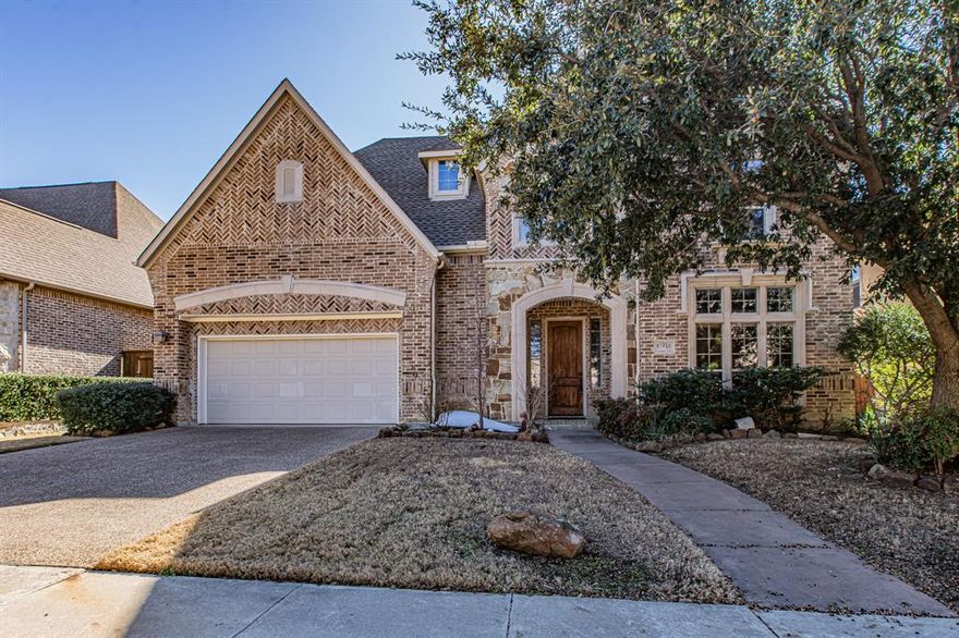 Step into a world of refined luxury in this stunning custom one of one residence, where impeccable craftsmanship and upscale finishes create an unforgettable first impression. A dramatic winding iron staircase anchors the elegant entry, immediately showcasing the home’s grand sense of style coupled with rich & abundant, hand-scraped hardwood floors. Just beyond, a sophisticated dining room sparkles beneath a statement chandelier and flows seamlessly into a beautifully appointed wine room—perfect for hosting unforgettable gatherings. A distinguished study offers a private retreat, featuring custom built-in bookshelves and an expansive desk ideal for working from home or quiet reflection all while being adorned with tasteful COFFERED ceilings. Throughout the home, exquisite custom wall treatments, rich hand-scraped hardwood floors, and classic plantation shutters highlight the attention to detail at every turn. The gourmet kitchen is nothing short of spectacular, designed to impress even the most discerning chef. Outfitted with premium stainless-steel appliances, including a smart dishwasher and double ovens, it combines function with elegance that contrast the rich wood stain of the custom cabinetry. An oversized island with a breakfast bar invites casual dining and conversation, while antiqued glazed cabinetry adds warmth and timeless sophistication. Designed for both luxurious everyday living and effortless entertaining, this exceptional home delivers comfort, beauty, and elegance in every thoughtfully curated space. All while being situated in one of DFW's most coveted and growing areas! You're a stone's throw away from Grandscape, Headquarters Dr. where all of the biggest businesses in the WORLD have their main hub, and situated just conveniently off of Highway 121 & Legacy Dr. You have the tech Hub of DFW, multiple restaurants, Legacy West, The Star, Hotels, and many other incredible amenities within arm's reach at every turn. Make this yours TODAY!